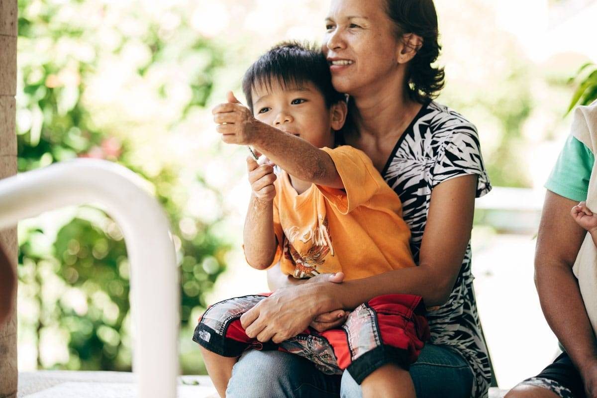 Woman holding young boy.
