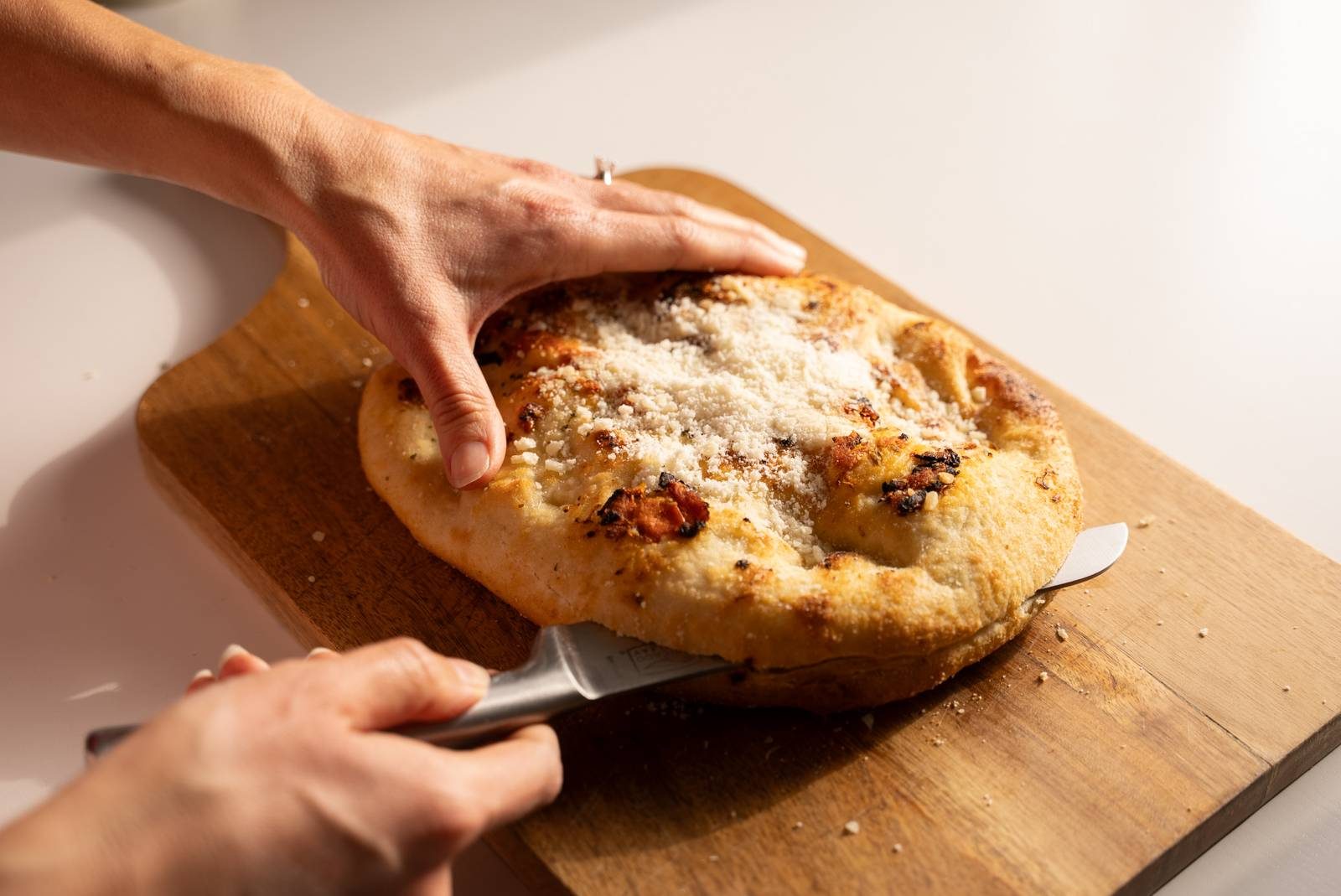 Slicing focaccia bread.