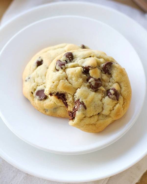 Chocolate chip cookies on a white plate.