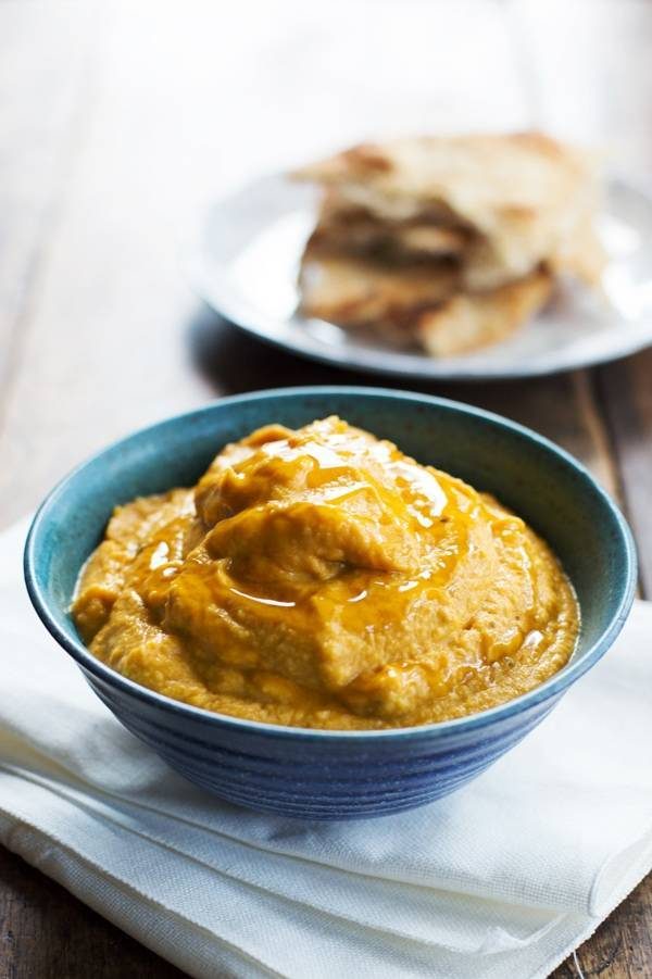 Roasted Garlic & Rosemary Pumpkin Hummus in a blue bowl.