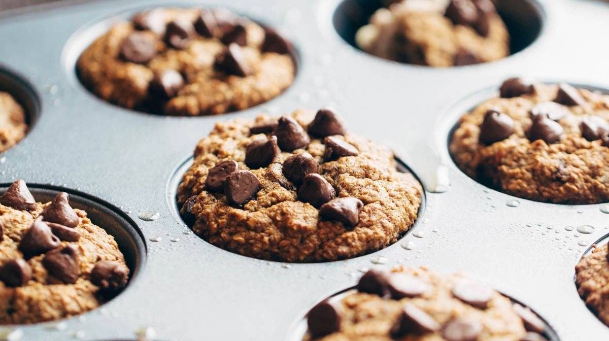 Banana Bread Muffins spread with butter.