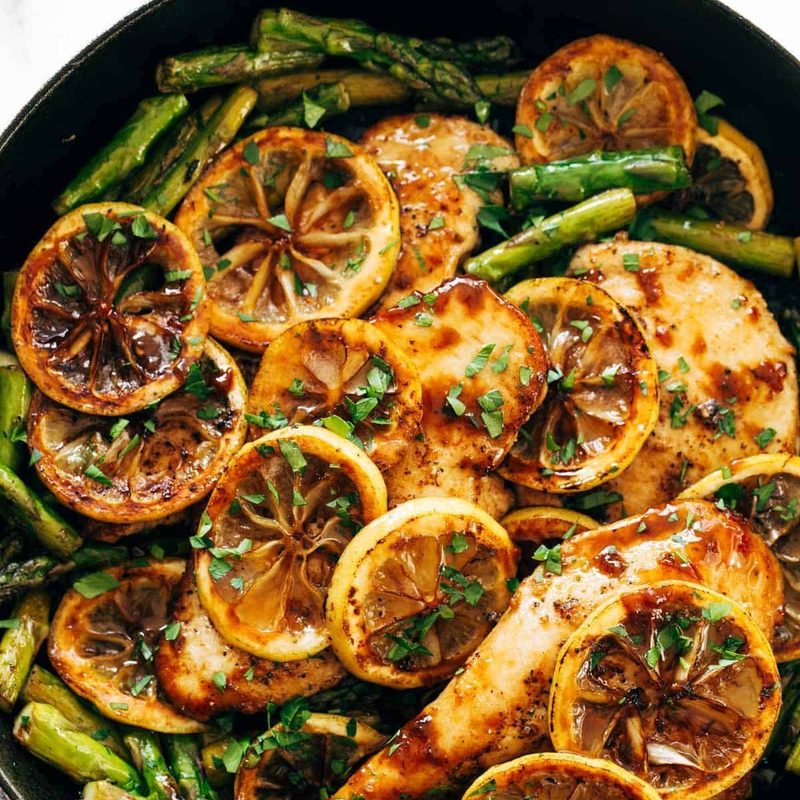 Lemon chicken with asparagus in a pan
