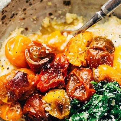Roasted Tomatoes with Goat Cheese Polenta in a bowl with a fork.