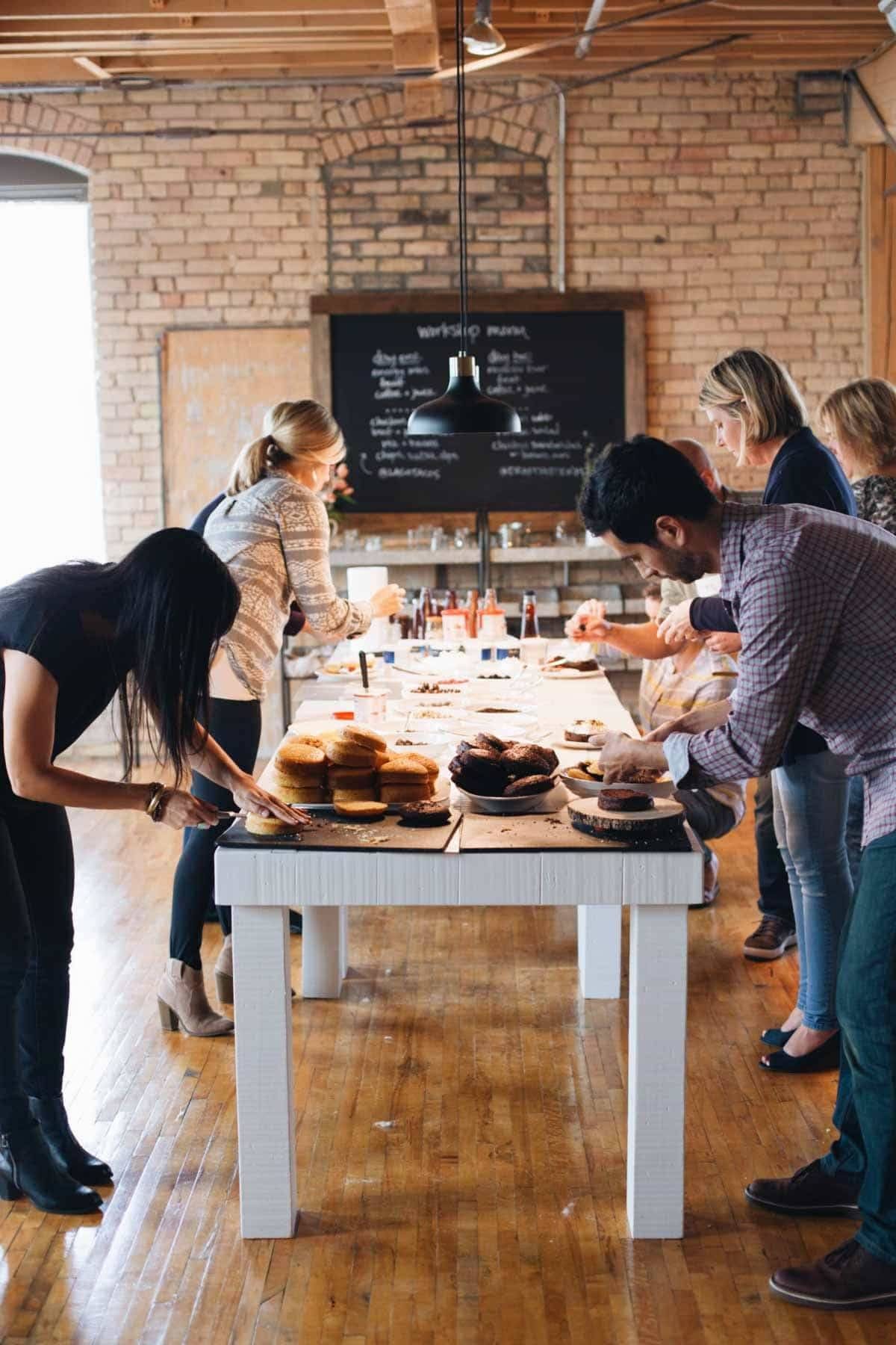People around a table styling food.