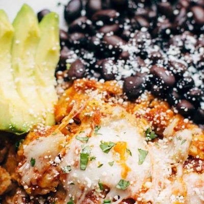 Sofritas Casserole on a plate with black beans and avocado.