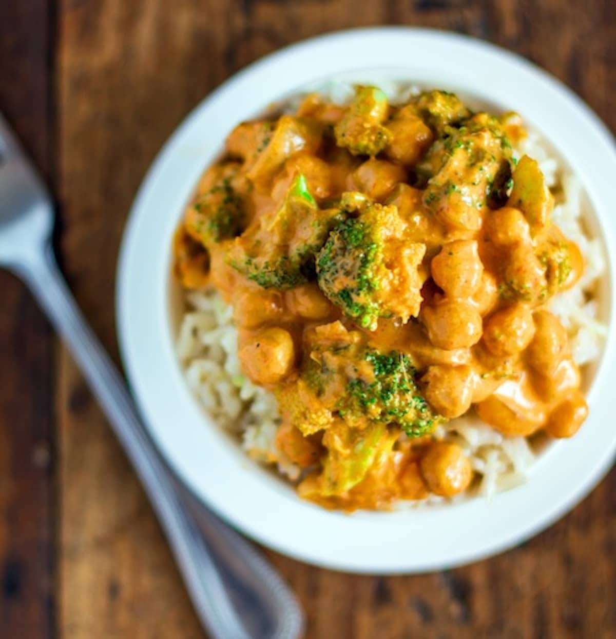 Coconut curry with broccoli and chickpeas and a creamy coconut curry sauce in a white bowl.
