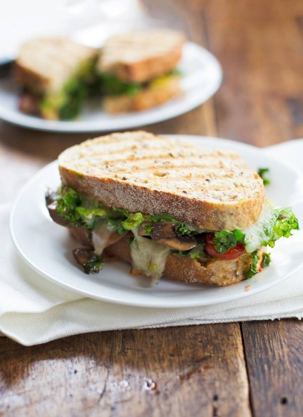 Avocado veggie panini on a plate.