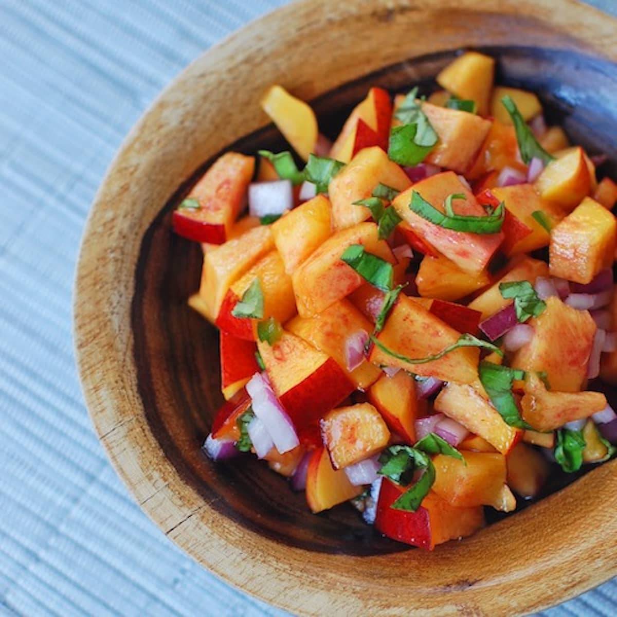 Nectarine basil salsa in a wooden bowl.